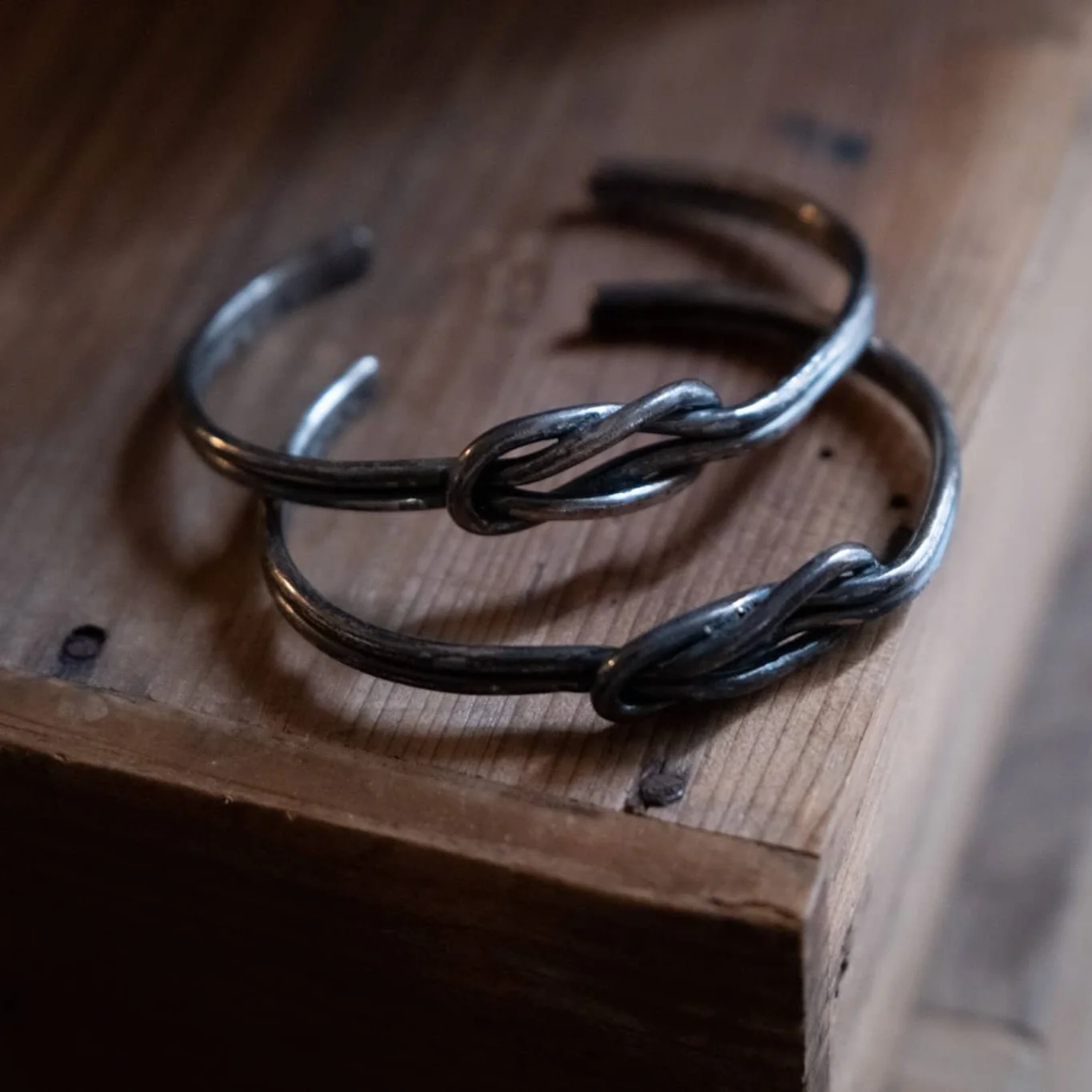 Two couple bracelets from owner on the wooden table