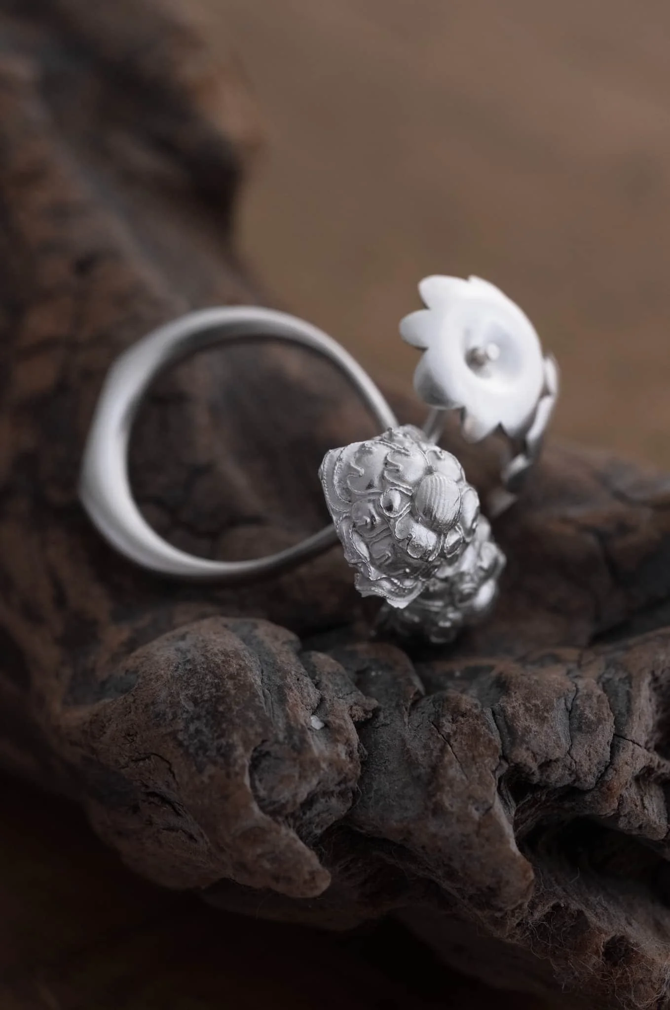 A redesigned flower shape ring show on wood