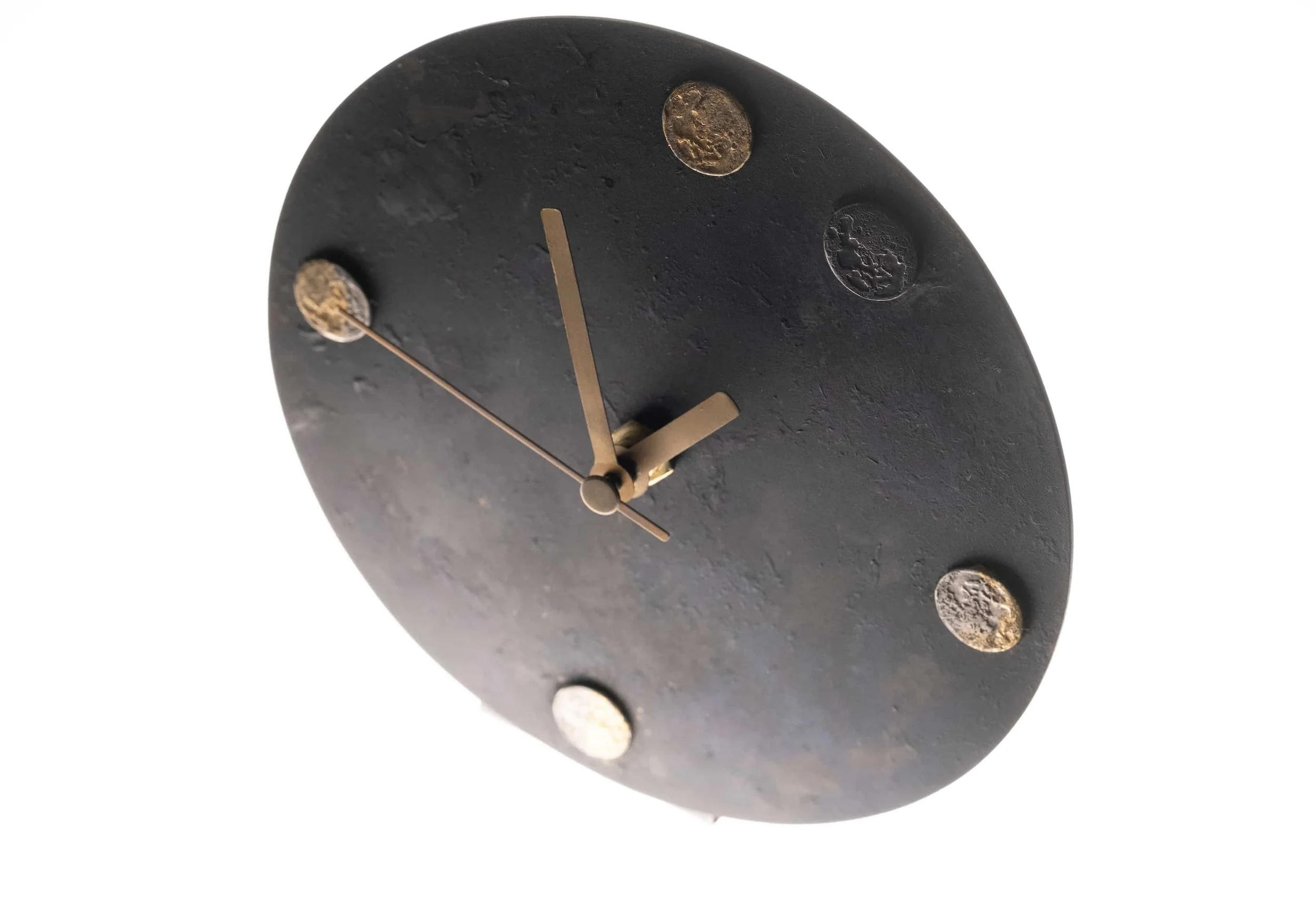 A brass moon pattern clock on a clear white background