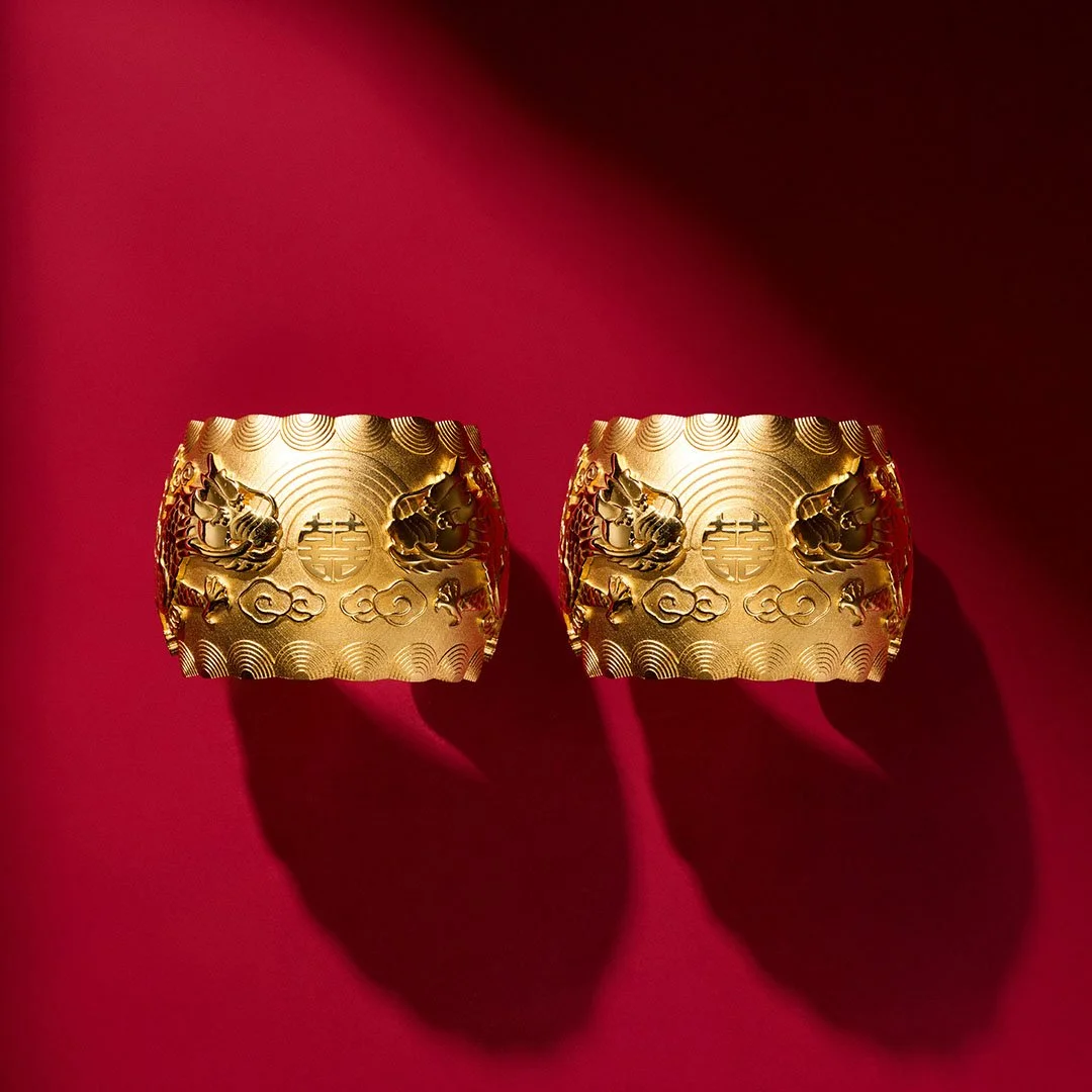 two gold double dragon bangle from Proud Pair Collection on the red plain background