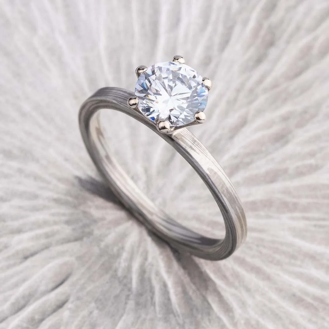 Perfectly Imperfect 200% diamond ring placed on sliver surface