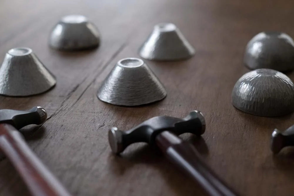 Forging tools and sake cup on wooden table