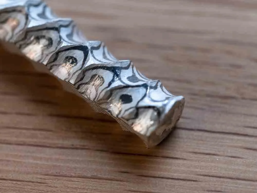 Mokume Gane with materials soldering together like a random wood grain pattern