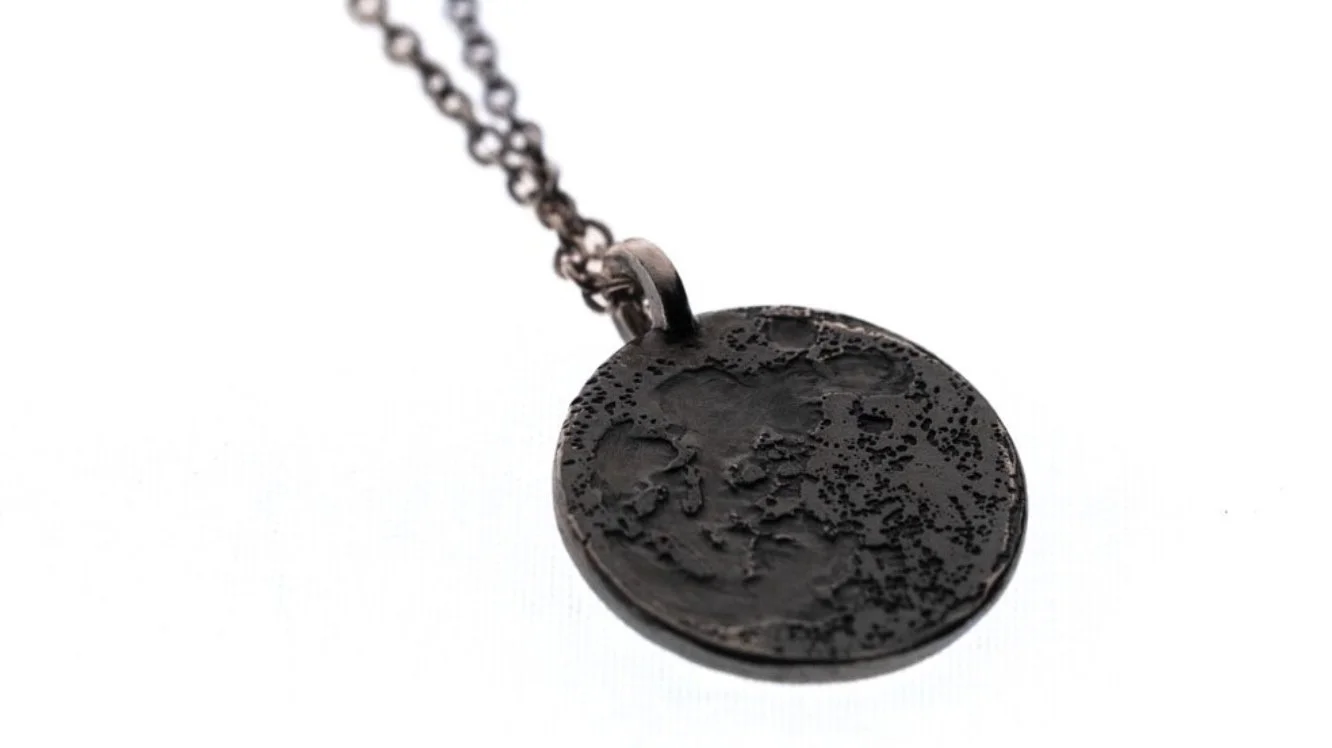 Moon necklace on a clear white background