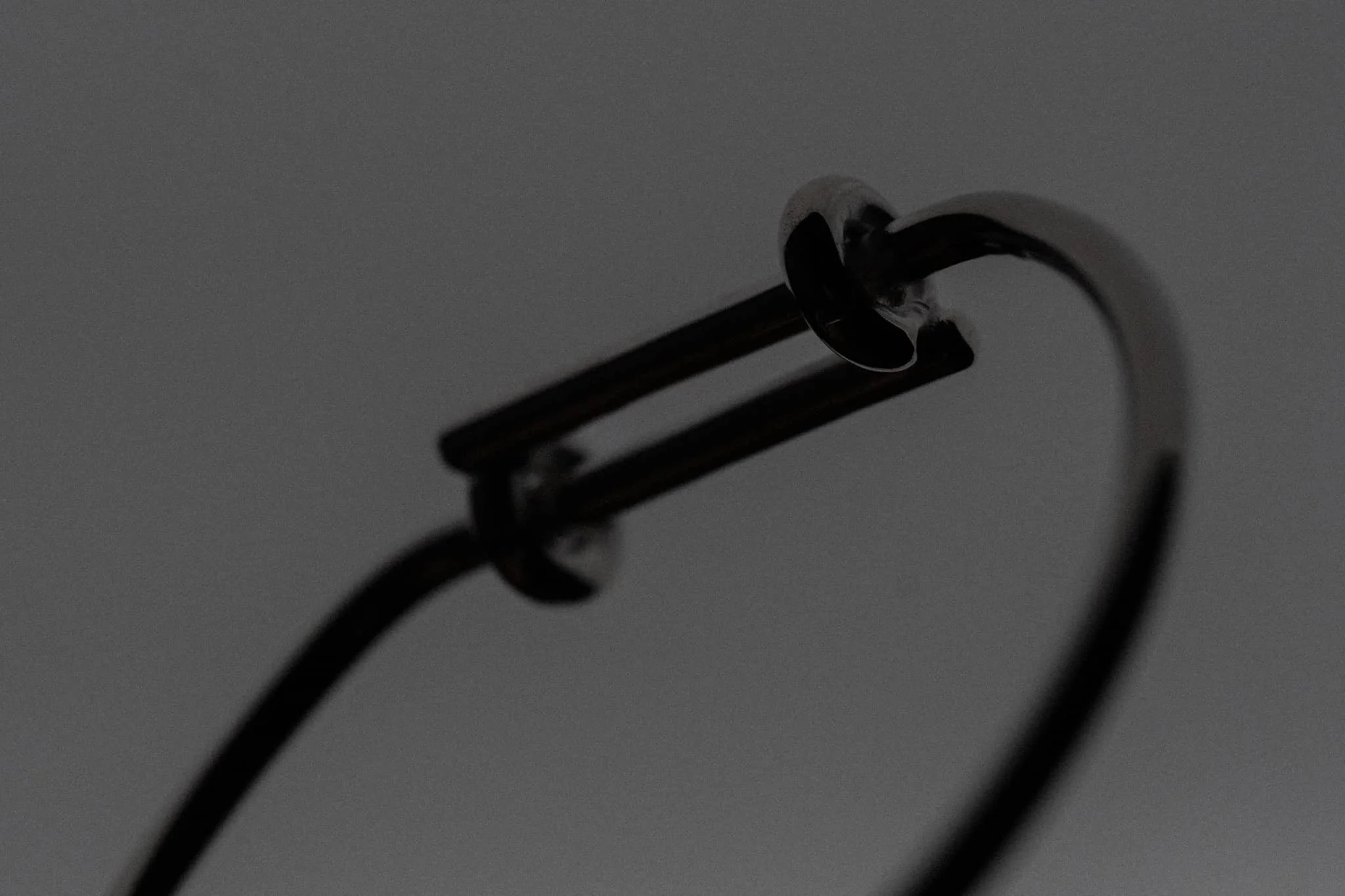 A baby bracelet in dark lighting under a white background