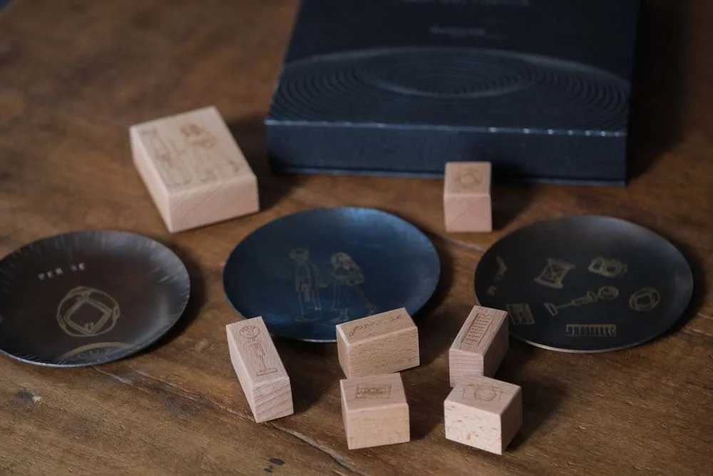 3 brass plate and stamps on the wooden table
