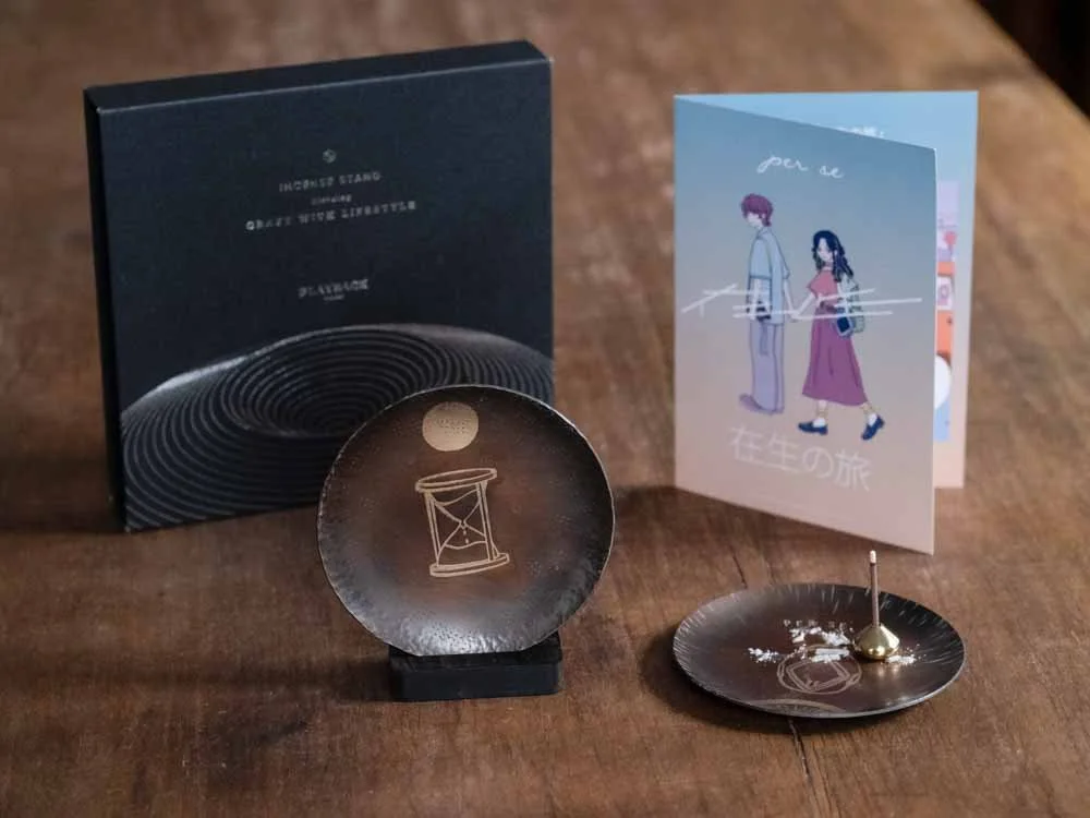 brass plate and the perse leaflet on the wooden table
