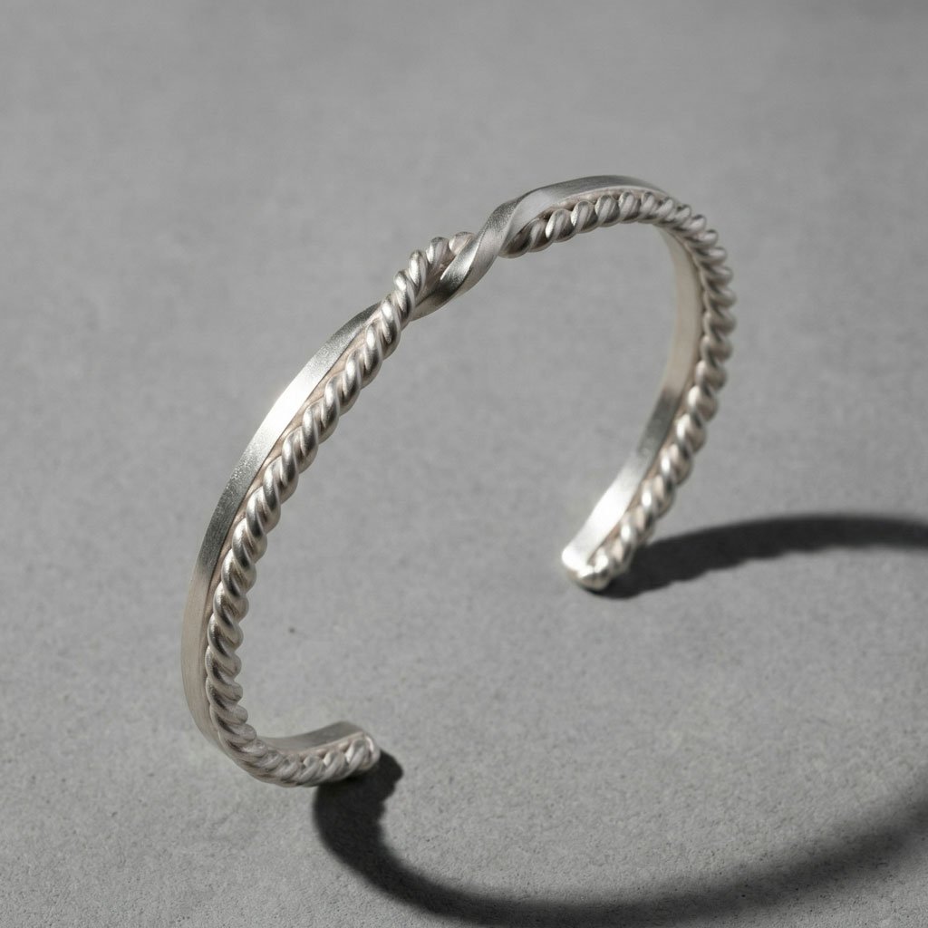 a silver Twin Souls Promise Bracelet on a silver surface
