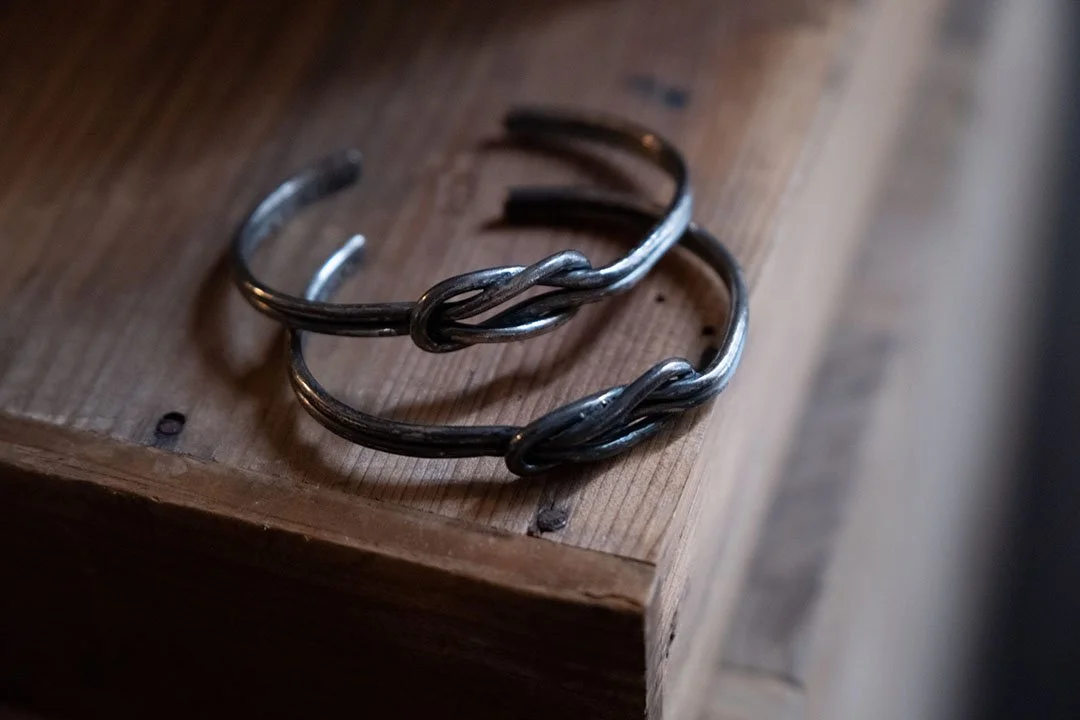 Pair of couple bracelets on the wooden table
