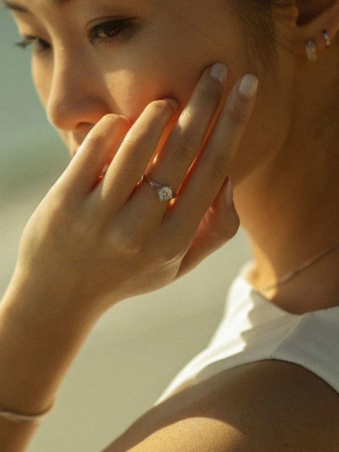 Woman wearing love nova diamond engagement ring in the middle finger