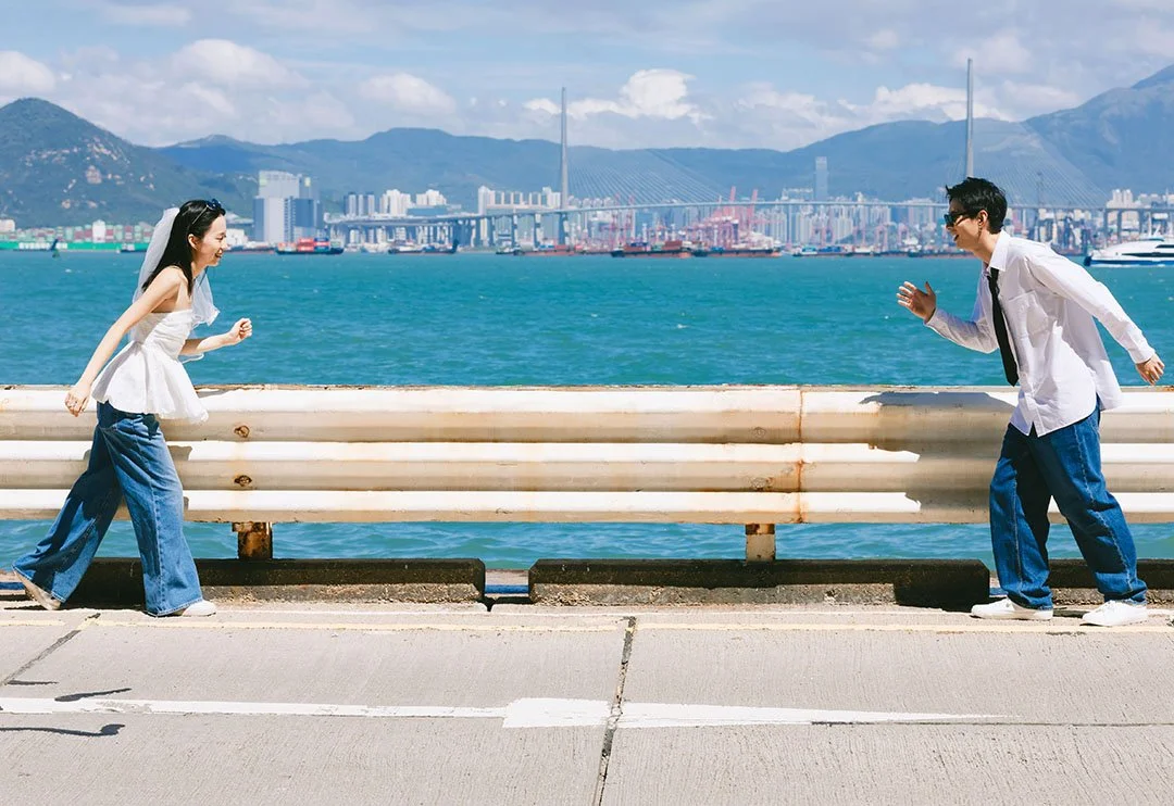 A couple running near the sea with white bar on the side