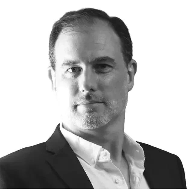 Black and white portrait of a man in a suit, with short hair and a neutral expression.