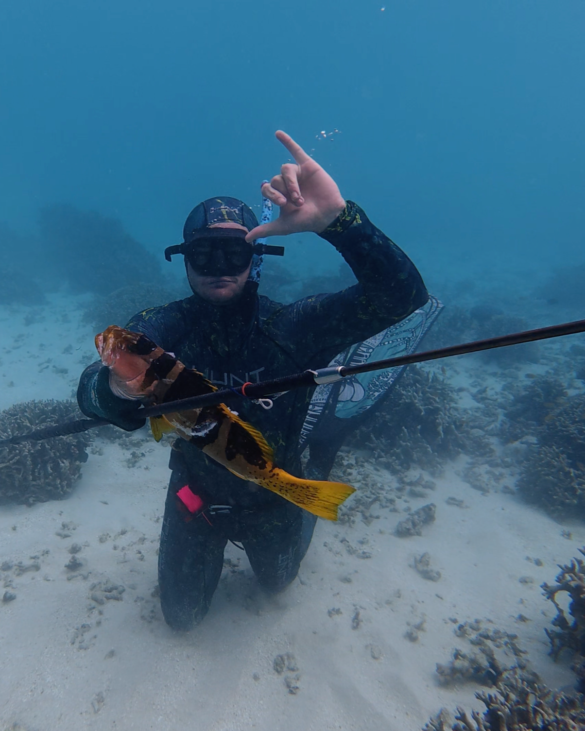 Xande wheldon holding a football trout shot with a pole spear in vanuatu