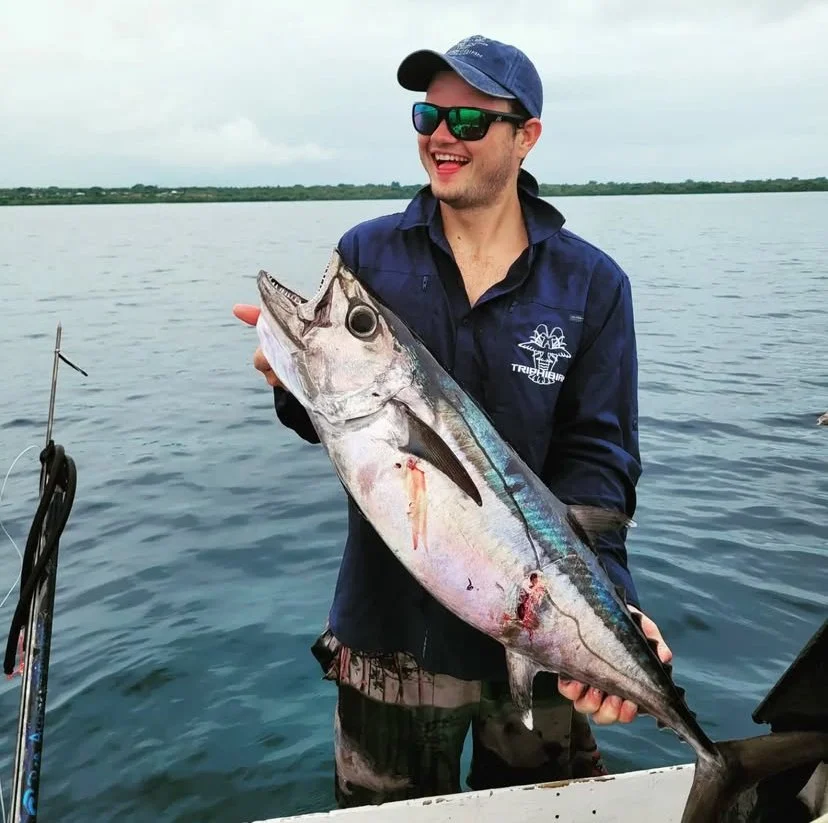 Xande smiling holding a dog tooth tuna caught in Vanuatu