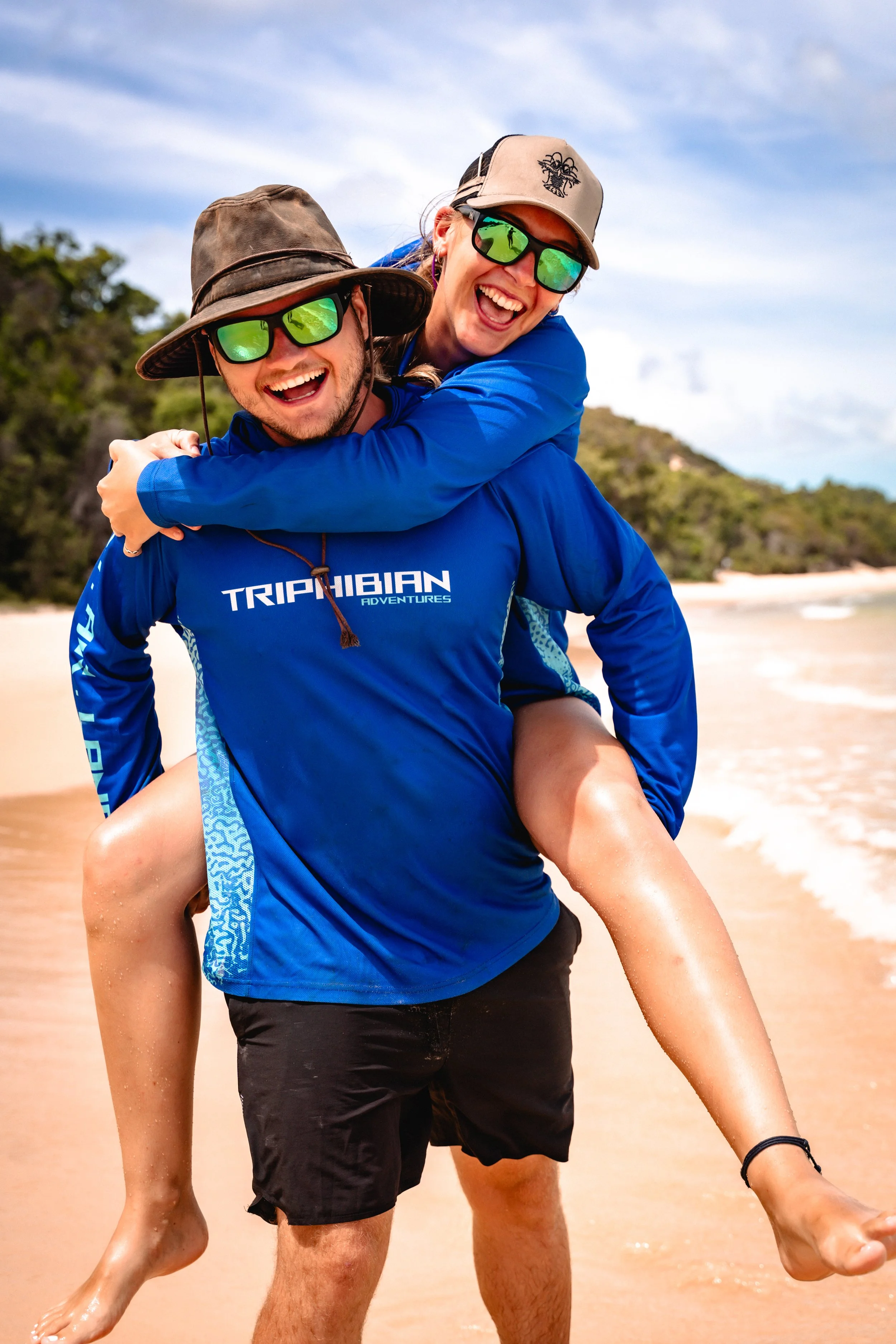 Brooke Mous and Xande Wheldon smiling together with triphibian fishing shirts on