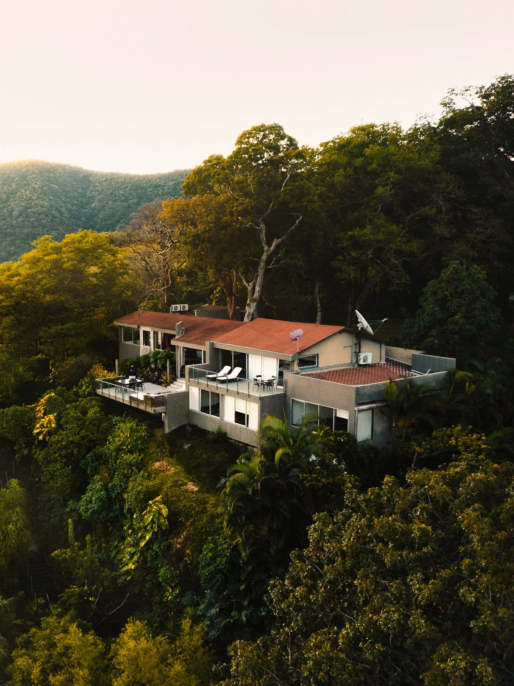 Boutique Airbnb VRBO Rental Vacation House sits in the tropical mountains nestled in a forest on a private island on a lake in El Salvador.