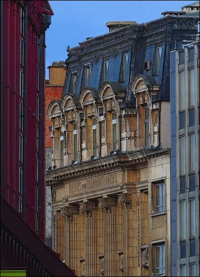 The Beurs voor Diamanthandel building in Antwerp's diamond district, its name carved above classical columns, framed by neighbouring buildings in a narrow street.