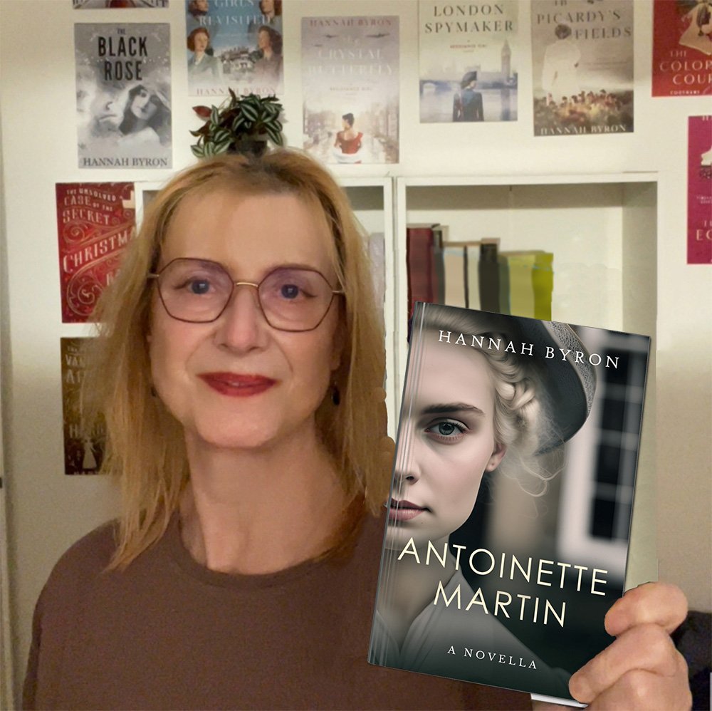 Hannah Byron holding her book Antoinette Martin while smiling