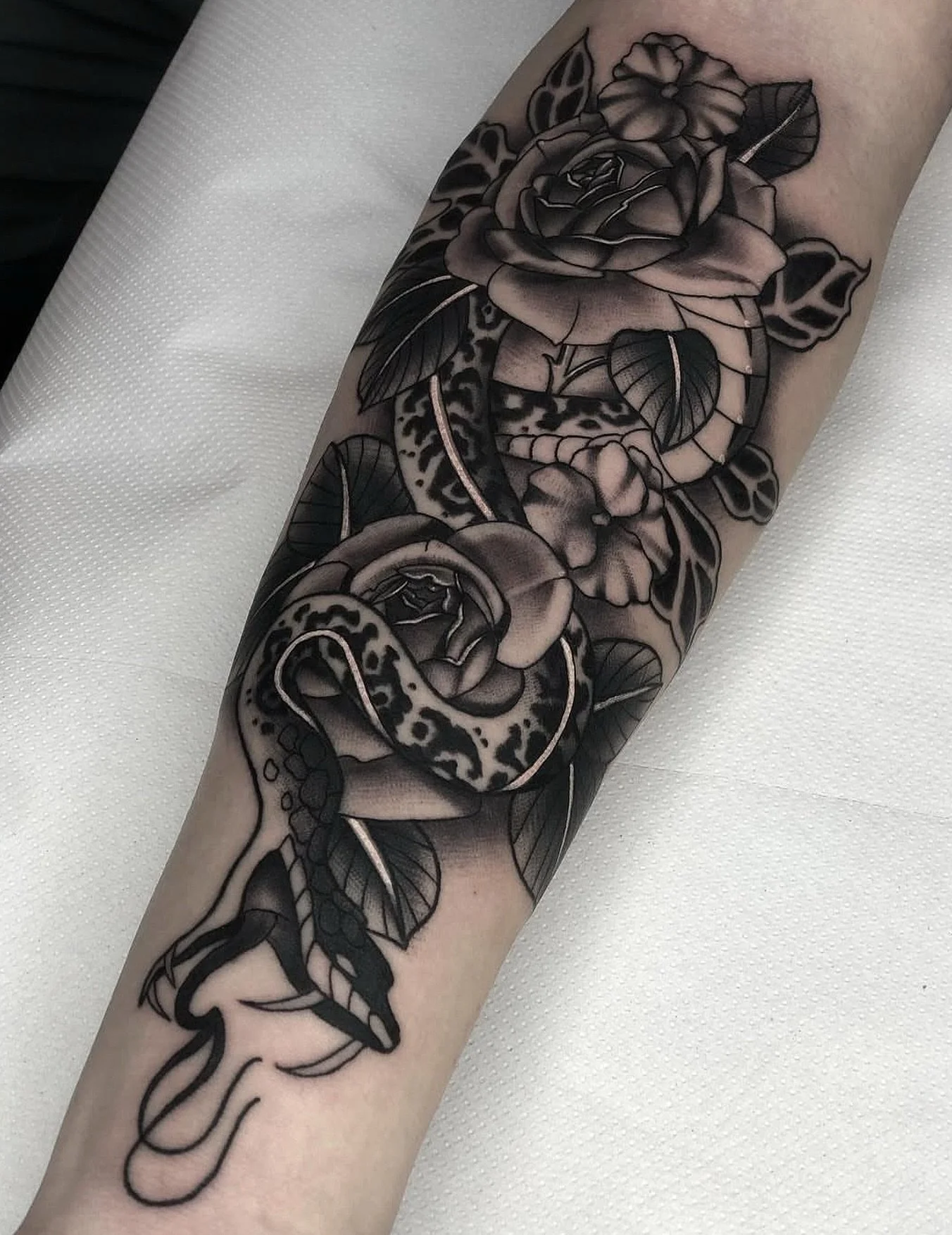 The serpent beneath from @ballytattoos 
.
Kyle specializes in bold clean blackwork, often influenced by classic tattoo imagery. Reach out to him directly to book your next tattoo 
.
#snake #snaketattoo #rosetattoo #blackwork #viper #forearmtattoo #br