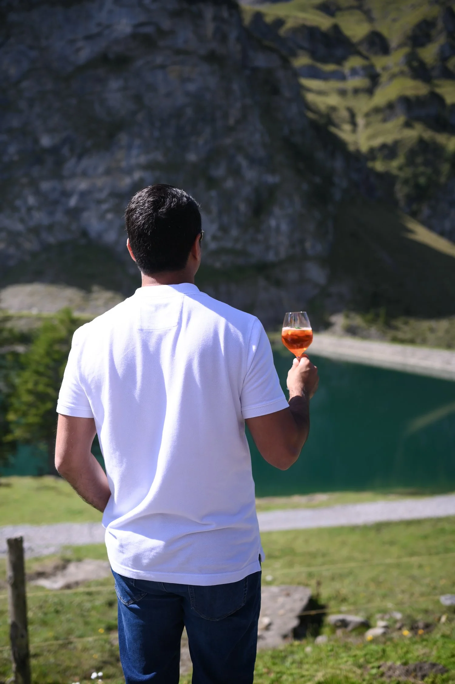 Man with aperol enjoying the lake in Switzerland