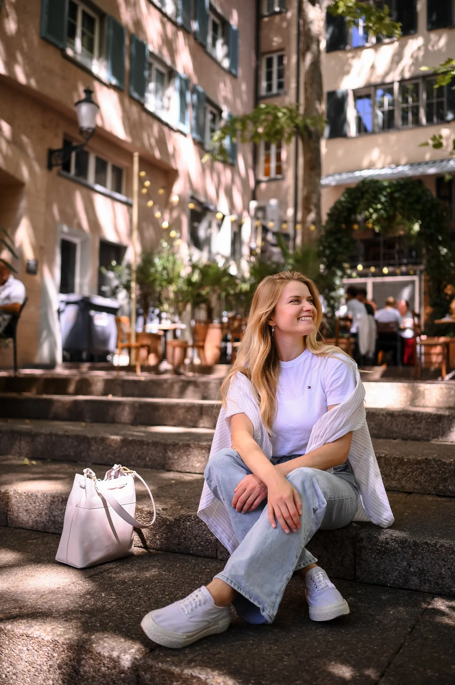 Smiling girl sitting on a ground