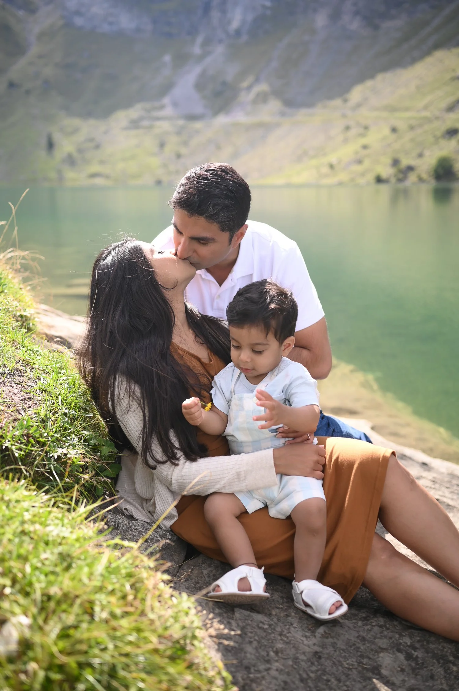 Parents with a child posing near lake
