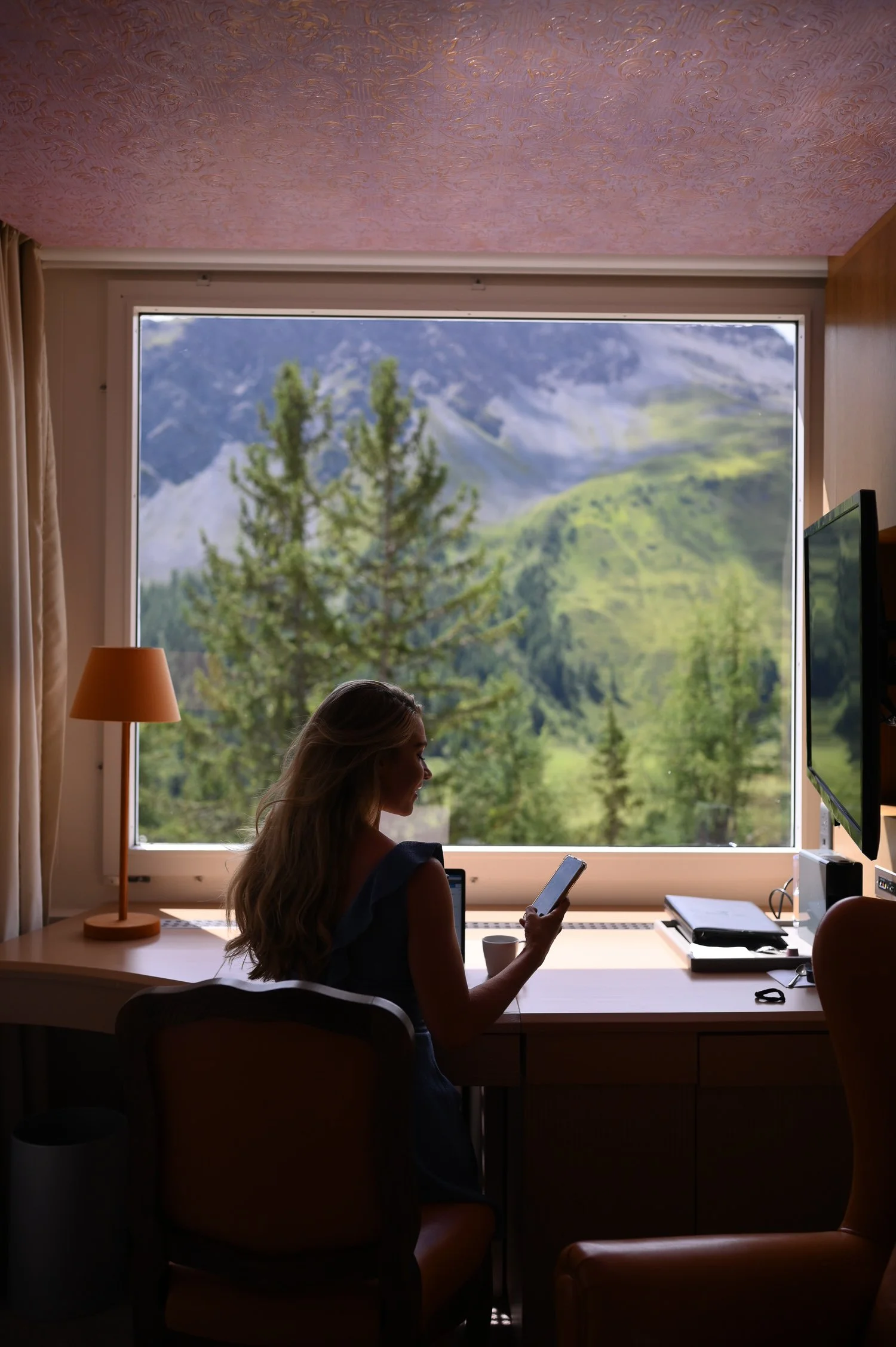 Girl working on a table with beautiful view