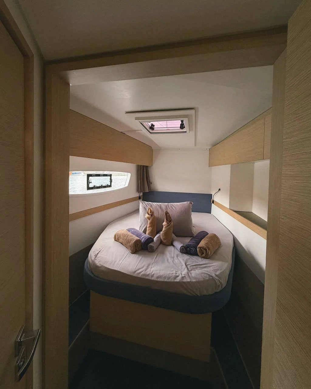 A front cabin on the catamaran with bed linen and pillows