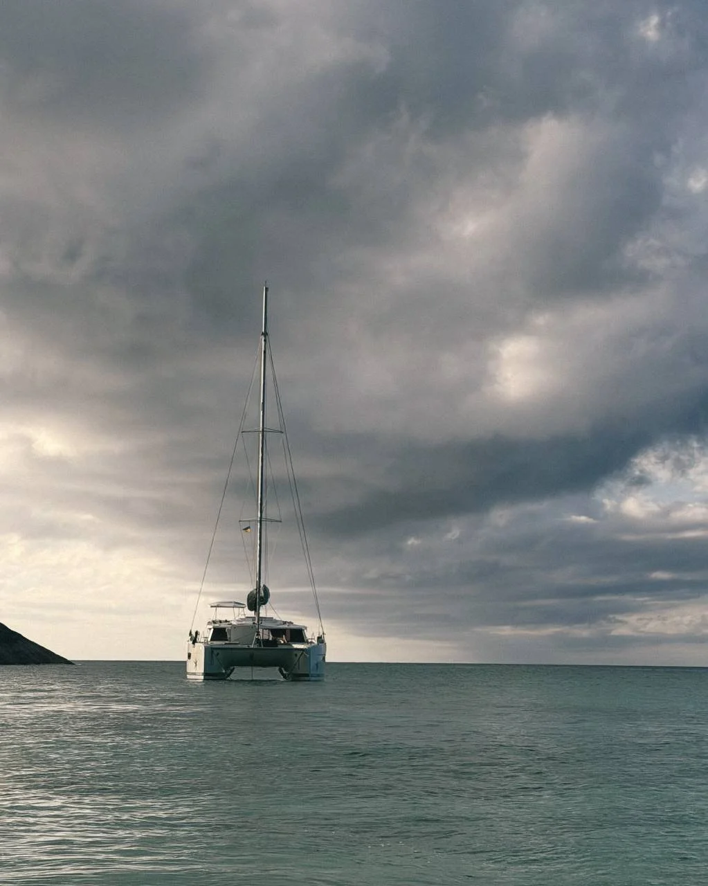 Sailing catamaran in the cloudy weather