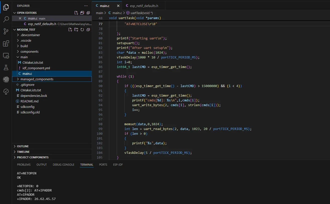 Screenshot of a computer screen displaying a code editor with C programming code related to UART communication and some terminal output showing AT commands and IP address.