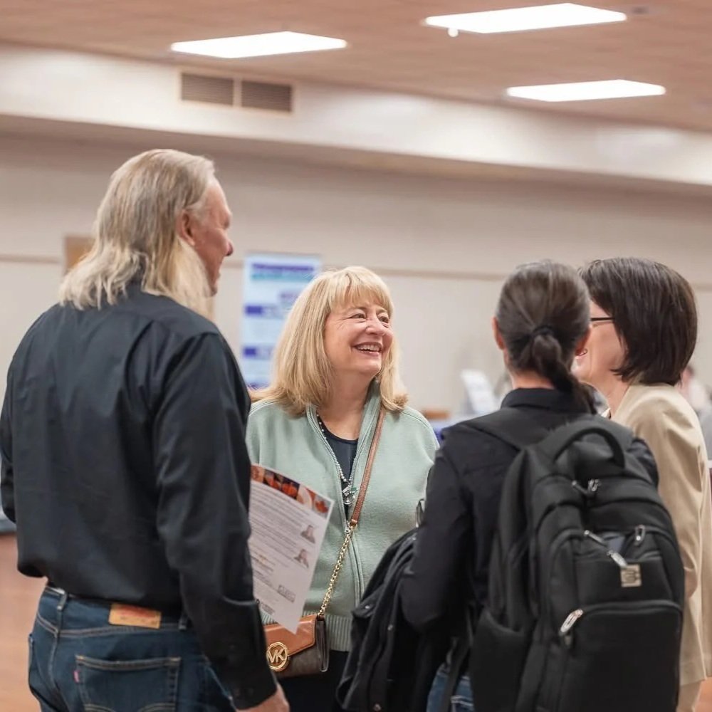 Attendees standing and talking together during WDNBH’s annual NDEAM Training Event.