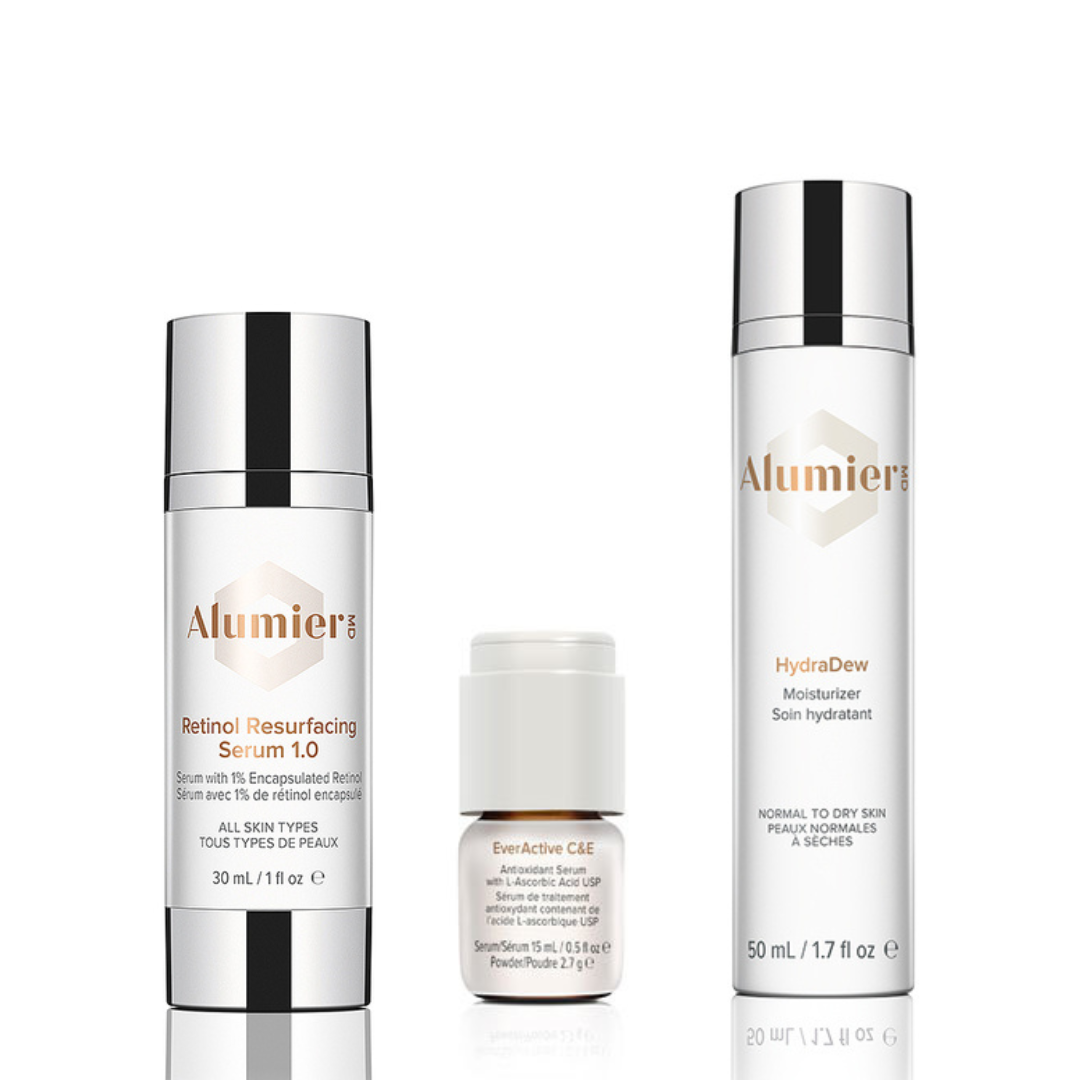Three skincare products from Alumier, including Retinol Resurfacing Serum 1.0, EverActive C&E serum, and HydraDew moisturizer, displayed against a white background.
