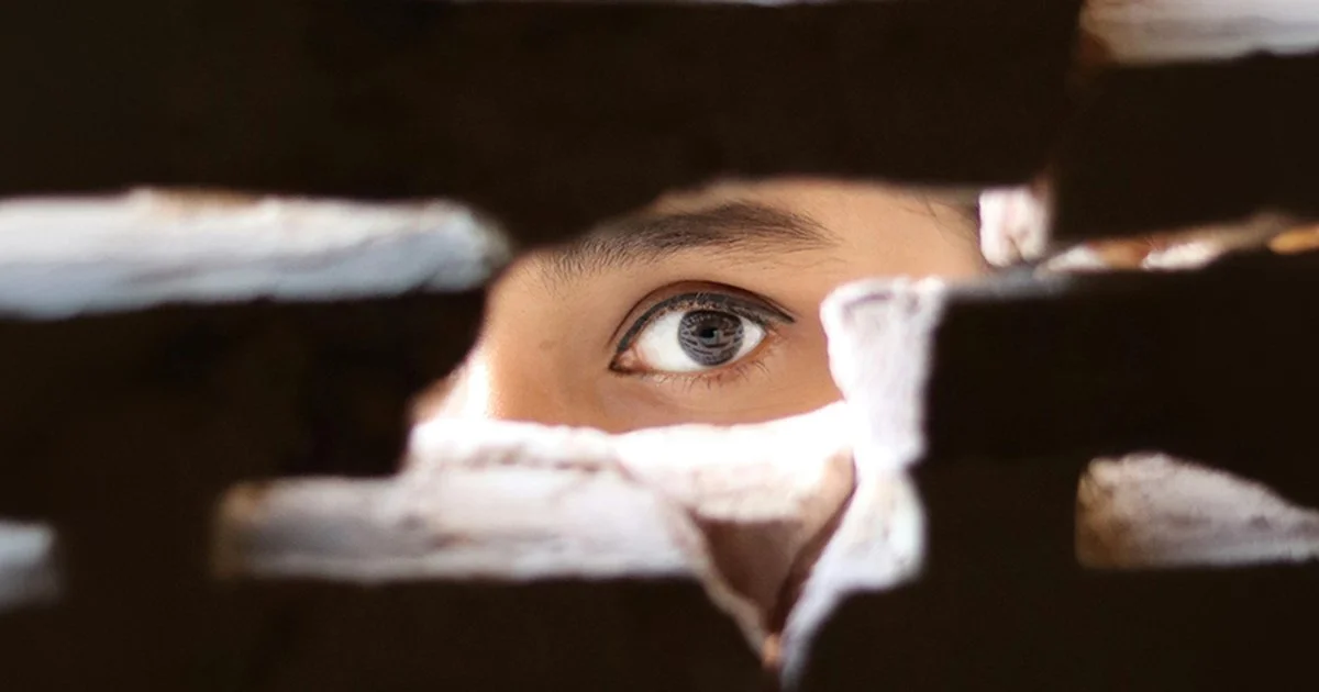 A person peering through a wall to represent Sodium & Co. filling in brand messaging gaps.