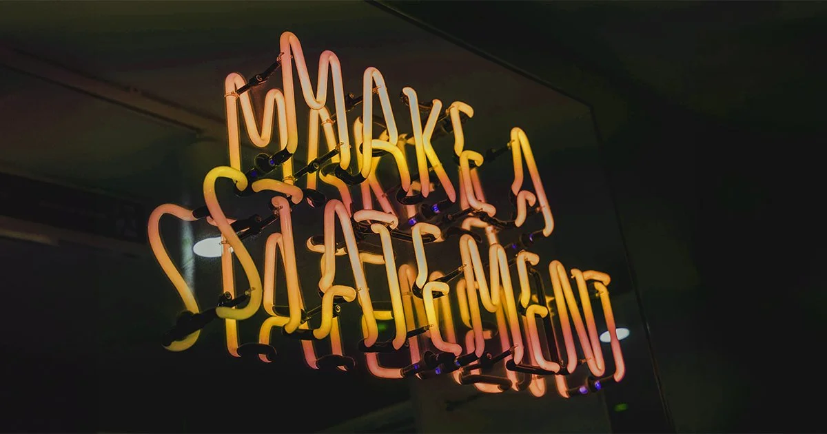 A neon sign saying "Make a Statement" to represent creating a brand positioning strategy.