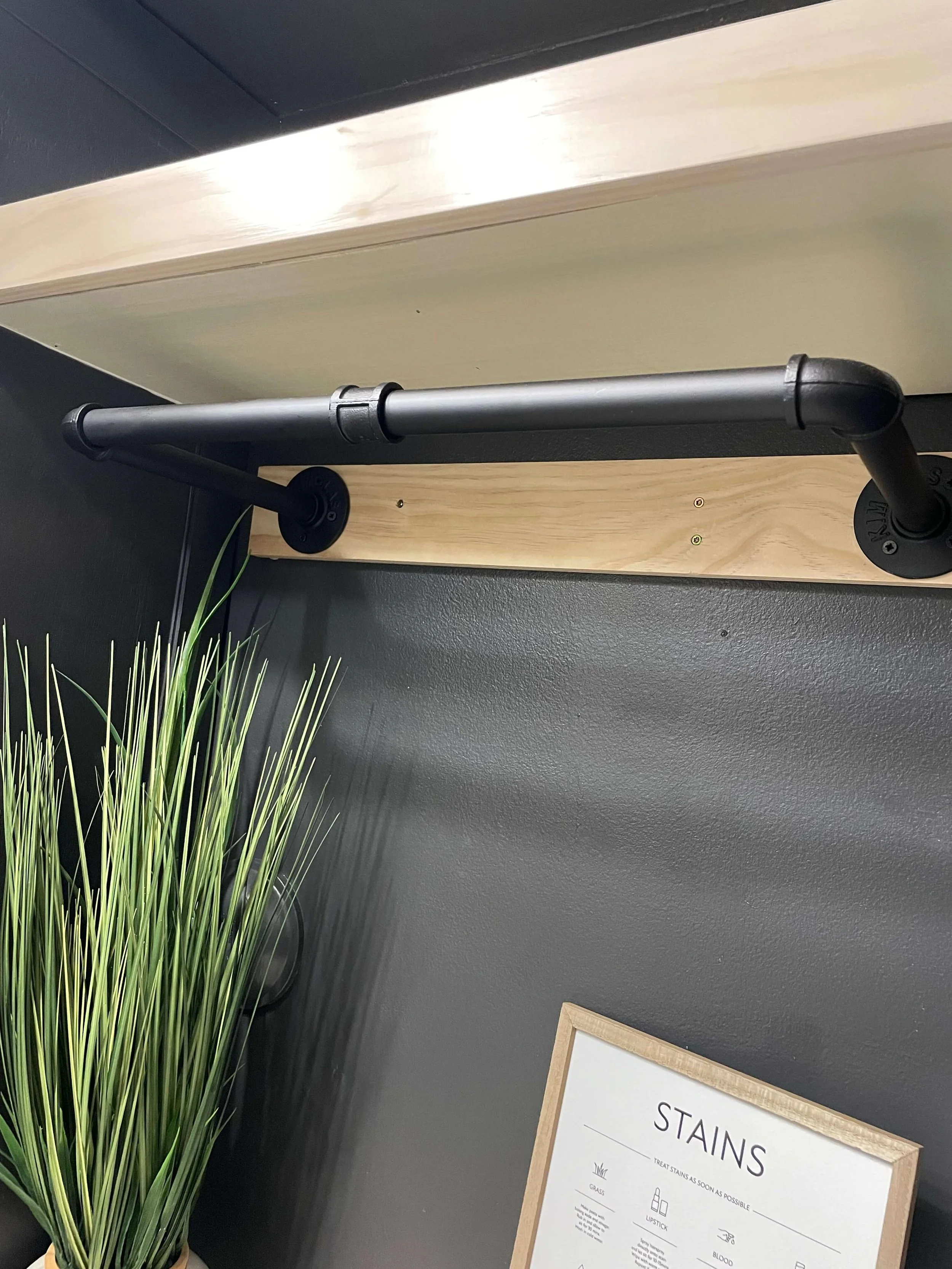 Laundry room hanging rod and floating shelf