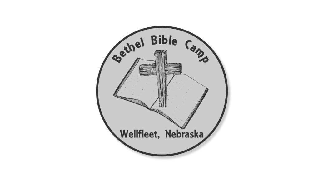 A circular emblem for Bethel Bible Camp in Wellfleet, Nebraska, featuring a sketch of an open Bible with a wooden cross on top of it.