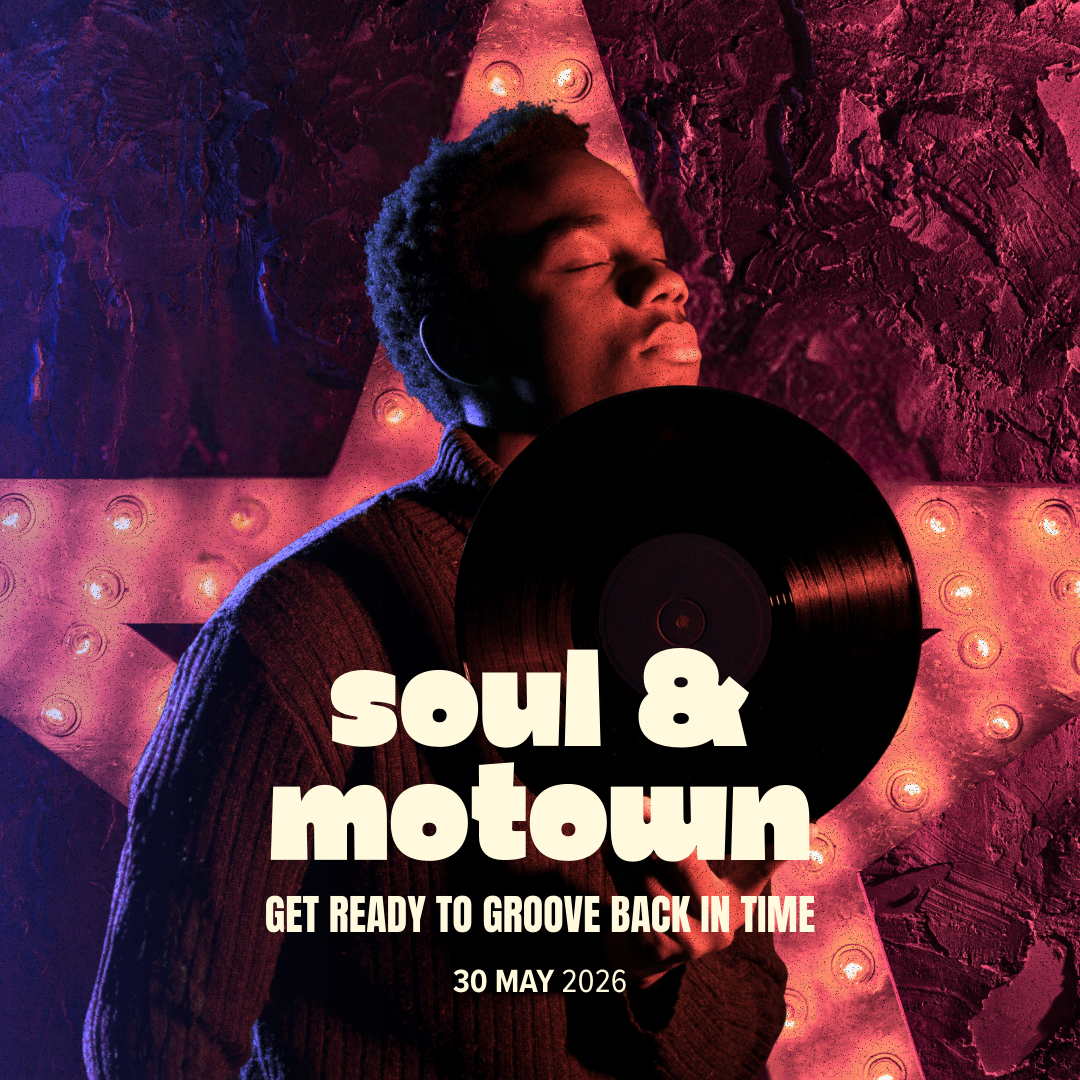 Young man with closed eyes holding a vinyl record, standing in front of a colorful neon-lit star-shaped sign.