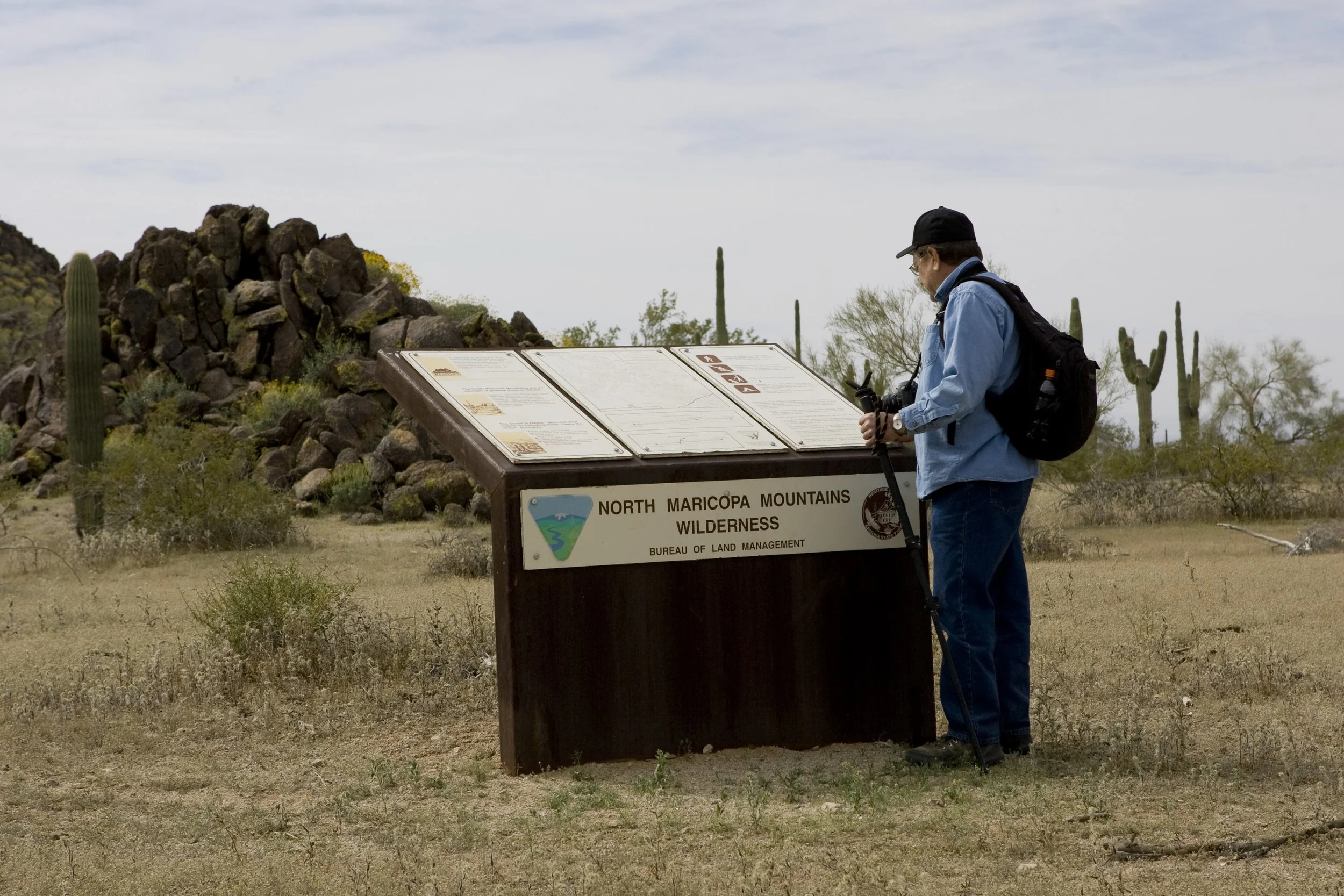 hiker reading a sign