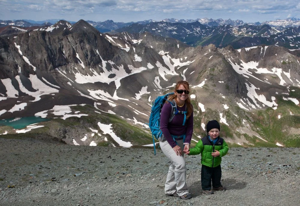 Parent and child on top of a mountain