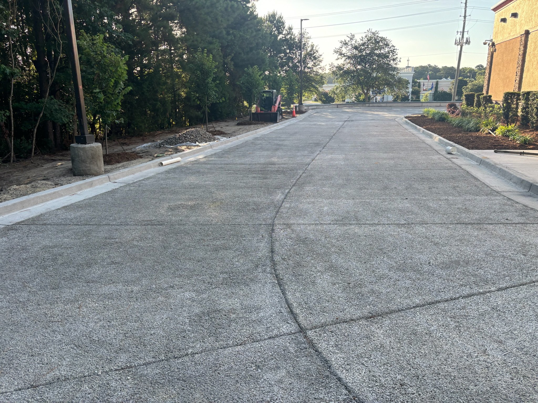 Industrial building construction with workers laying concrete floor.