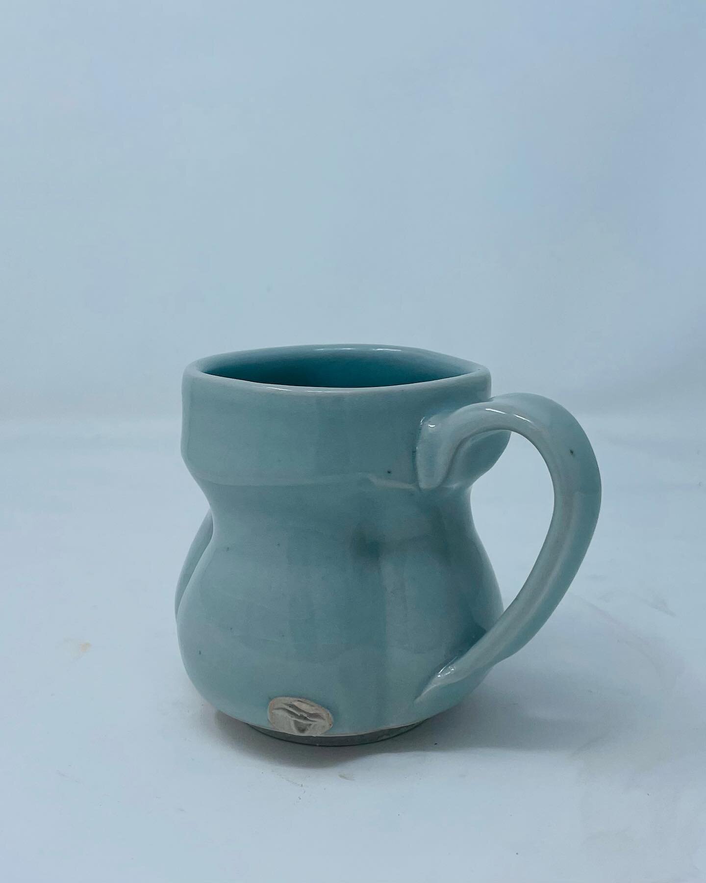 Porcelain mug fired in cone 10 reduction. Blue celadon glaze.