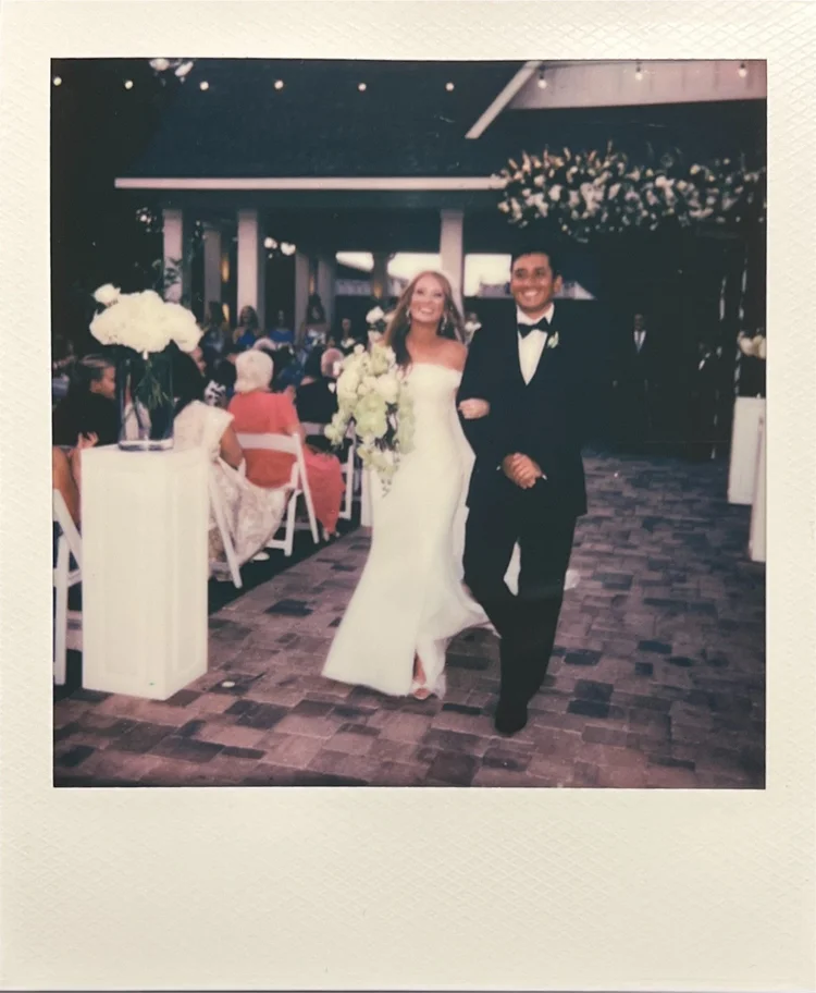 Polaroid of a couple walking back down the aisle