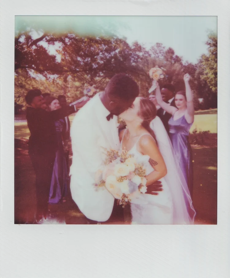 Polaroid of Moses and Taylor celebrating