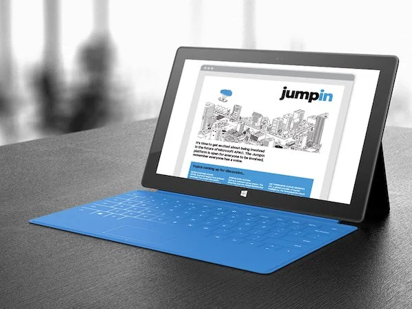 laptop with image of Microsoft "jumping" campaign on the screen