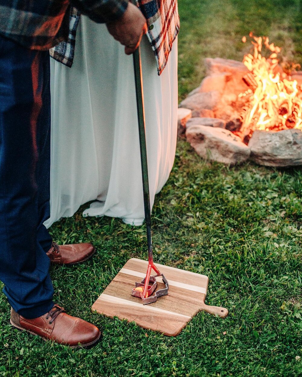Jennifer &amp; Chad&rsquo;s beautiful elopement day began with getting married just outside Glacier National Park followed by ending the night at their Airbnb. They grazed on a charcuterie board by a camp fire and branded a piece of wood to commemora