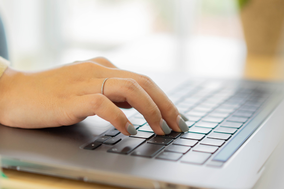 Woman typing on keyboard