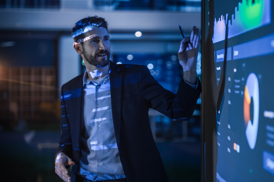 Man presenting on a digital whiteboard