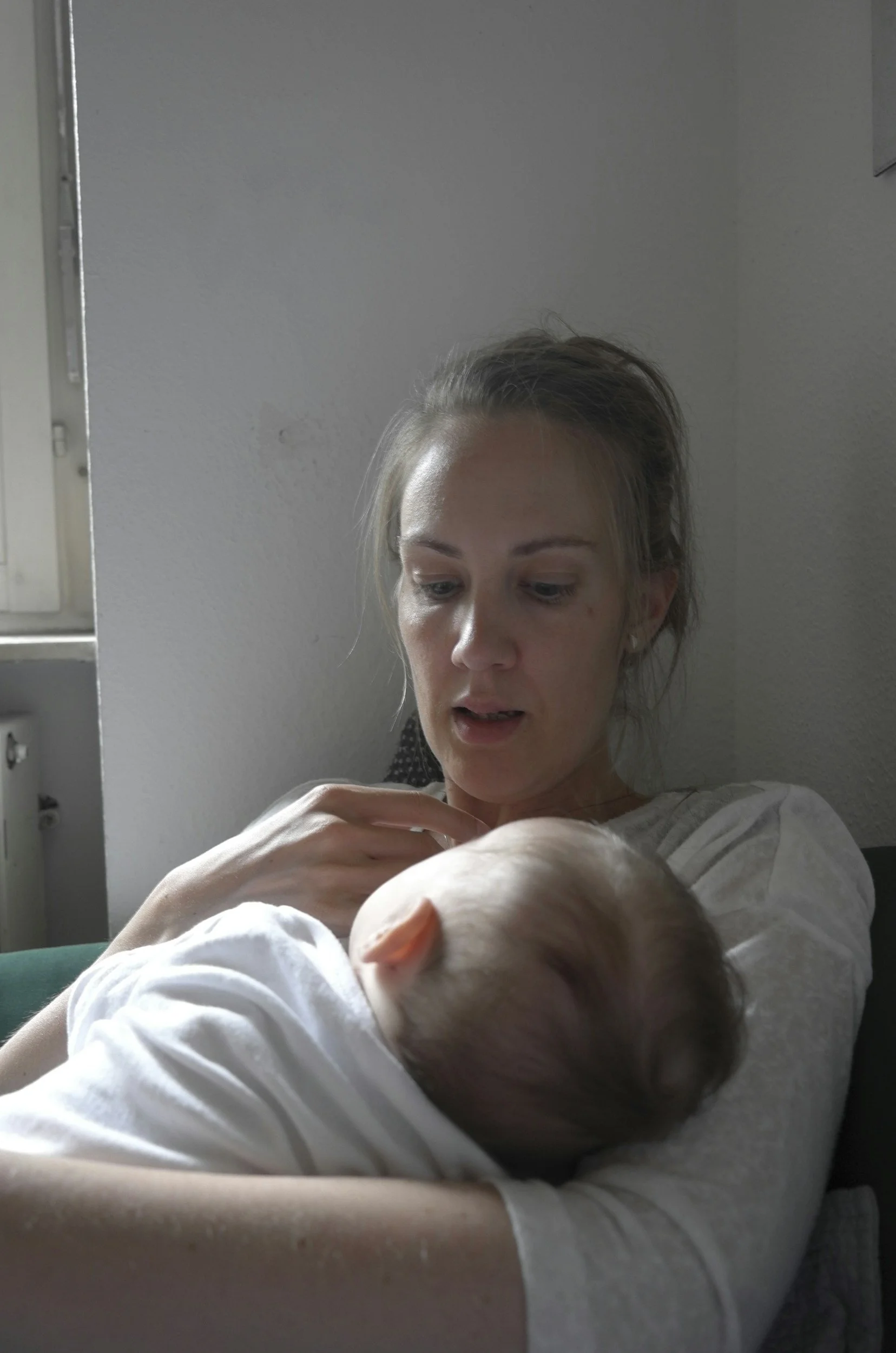 Tired mum with baby at night - when feeding to sleep stops meeting your needs it's worth looking at the full picture