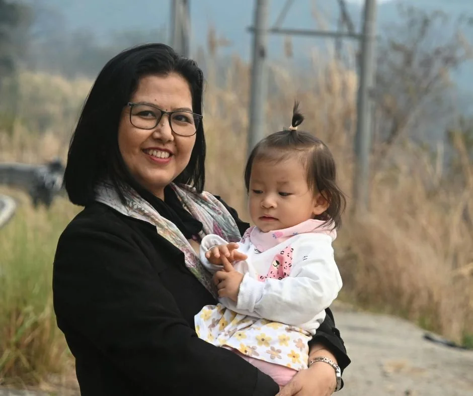 Parent holding baby outside in natural morning light to help adjust sleep after clocks go forward