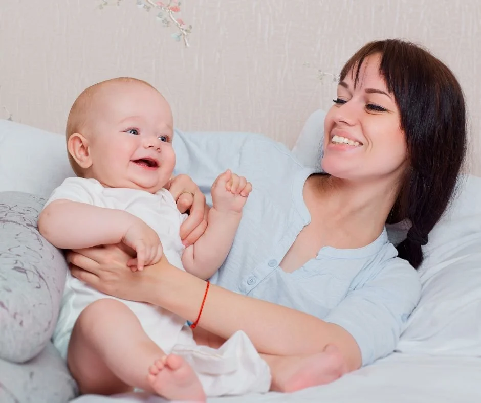 A mother lying with her baby on a bed, the closeness families weigh up when deciding they're ready